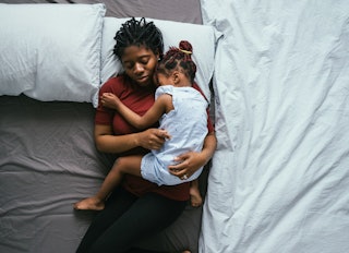 A young child sleeps on her mother in what is known as a "contact nap."