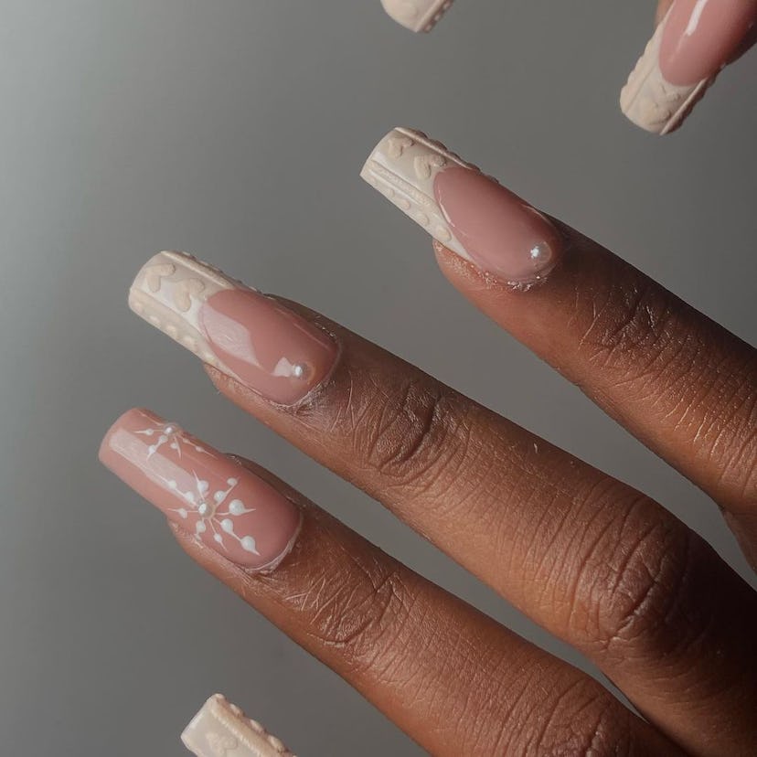 If you need a winter manicure design idea for 2023, these beige French tip sweater nails with pearl ...