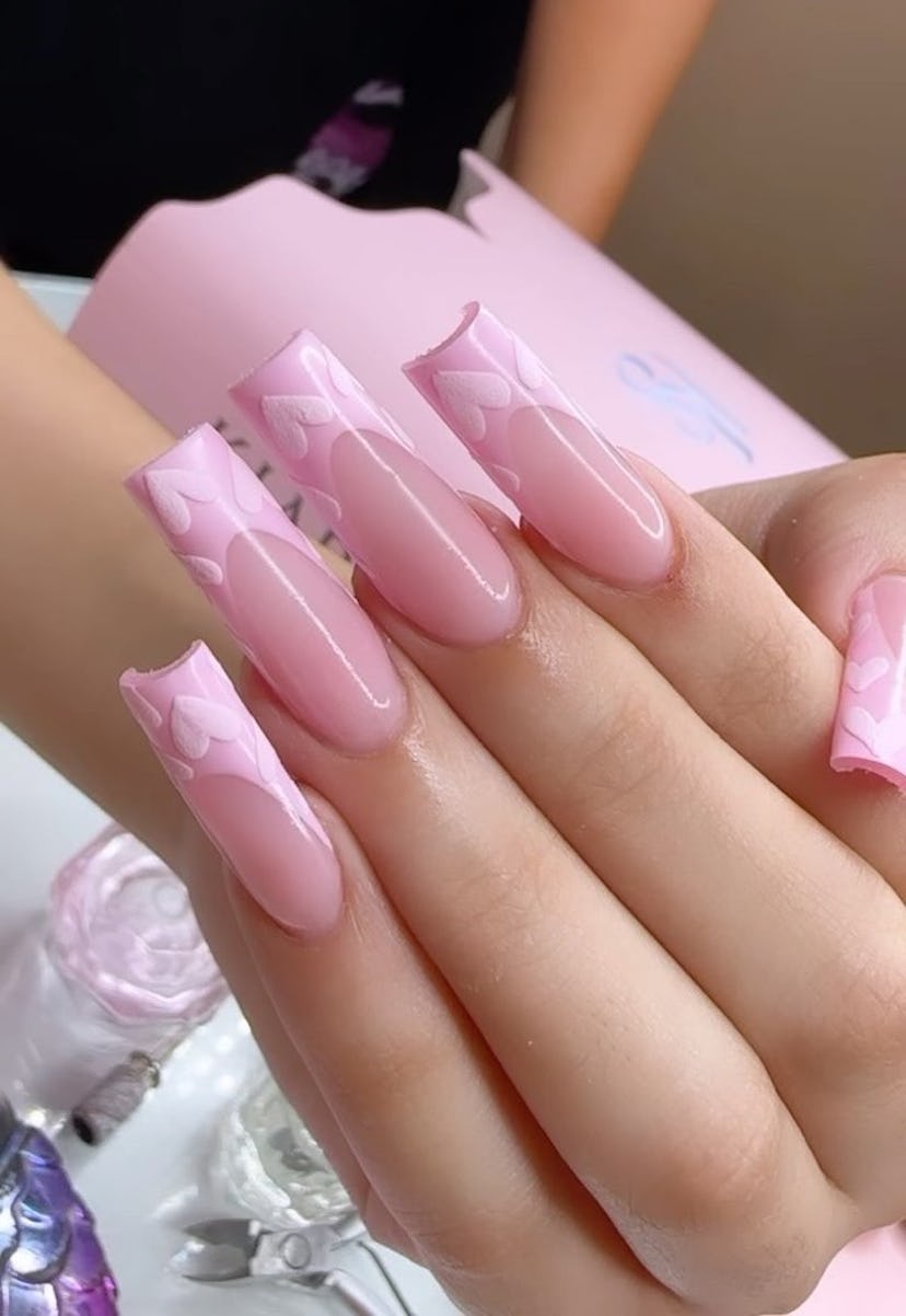 If you need a winter manicure design idea for 2023, these pink French tip sweater nails with hearts ...