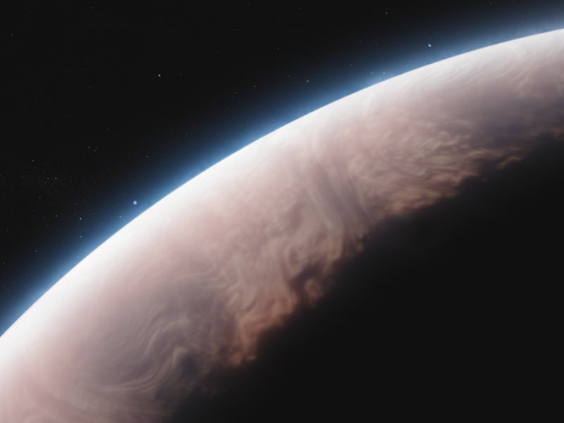 The curve of a planet against a backdrop of stars
