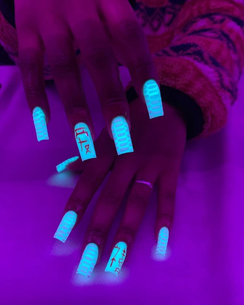 Blue croc glow-in-the-dark nails.