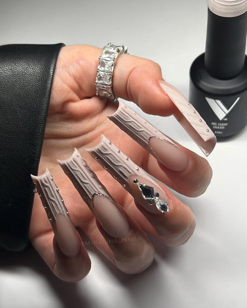 If you need a winter manicure design idea for 2023, these beige French tip sweater nails are on-tren...