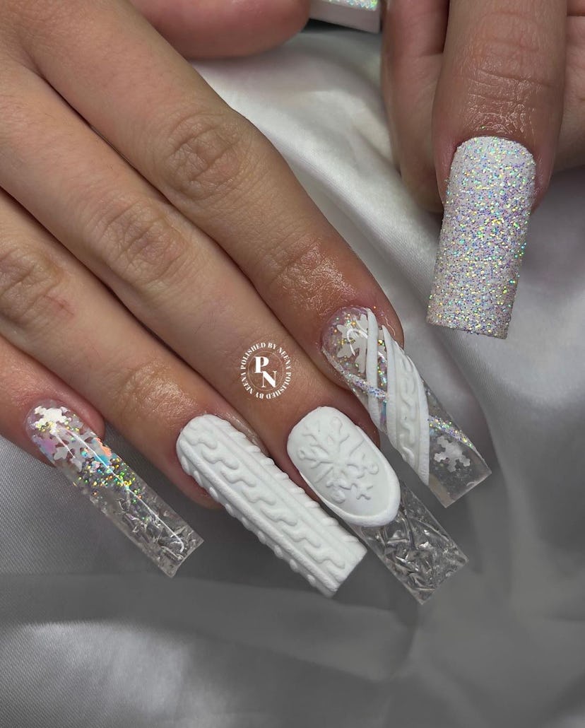 If you need a winter manicure design idea for 2023, these white snowflake sweater nails are on-trend...