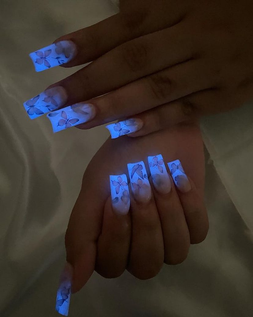 Blue glow-in-the-dark butterfly nails.