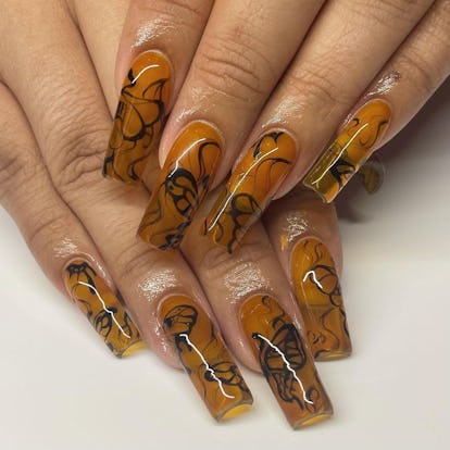 Smoky black swirls trendy Halloween nail design for 2023.