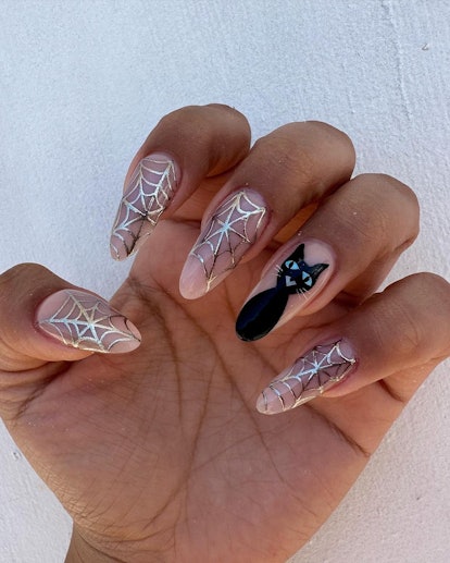 For simple Halloween nails, a silver chrome spiderweb nail art design is on-trend for 2023.