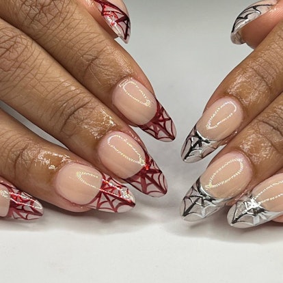 Chrome French tips with spiderwebs are a trendy Halloween nail design for 2023.Trendy Halloween Nail Designs For 2023