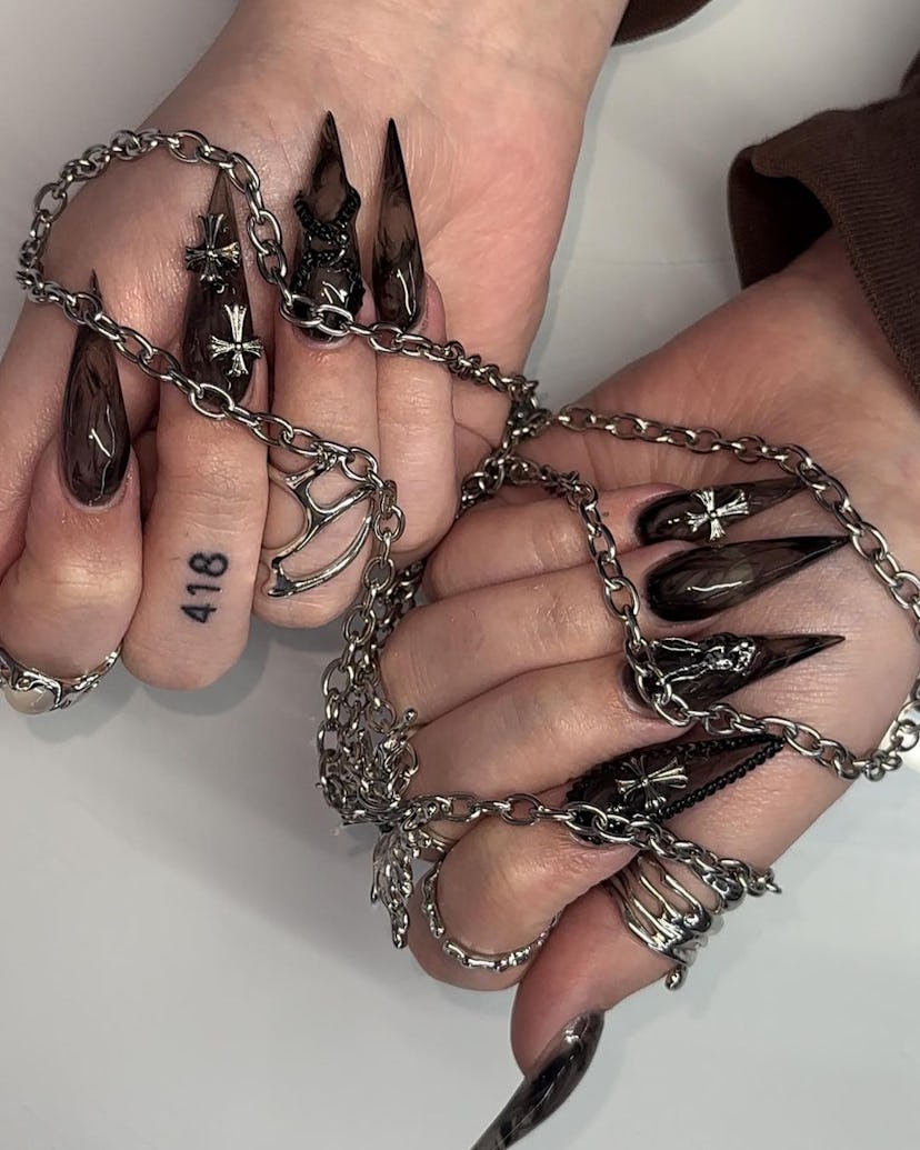 Smoky black acrylic stiletto nails are a trendy Halloween nail design for 2023.