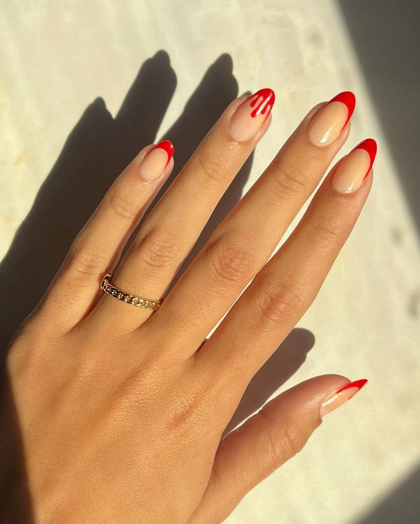 Red French tips are a trendy Halloween nail design for 2023.