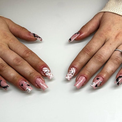 For simple Halloween nails for 2023, try mummy nail art against a nude nail polish.