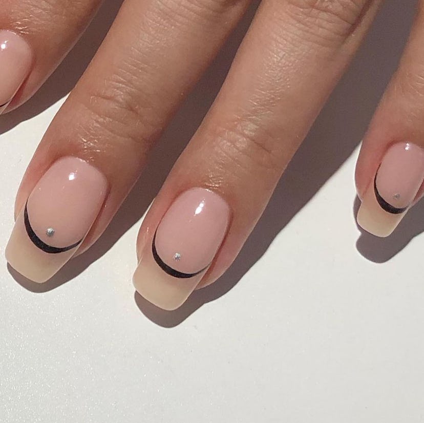 A simple and subtle Halloween nail art design for 2023, these tiny black crescent moons are great fo…