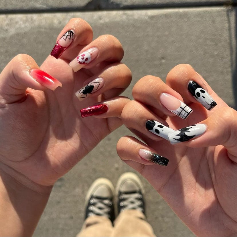 A mix of trendy Halloween nail designs for 2023 that includes spiderwebs, skulls, & more.