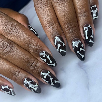 For simple Halloween nails for 2023, try black & white bone nail art. Trendy Halloween Nail Designs For 2023