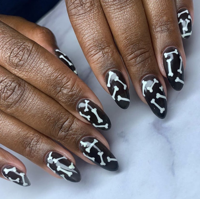 For simple Halloween nails for 2023, try black & white bone nail art.