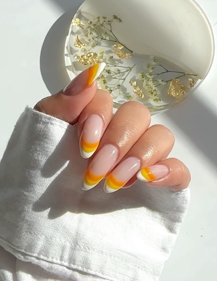For an on-trend Halloween nail art design for 2023, try white, yellow, & orange candy-corn inspired …
