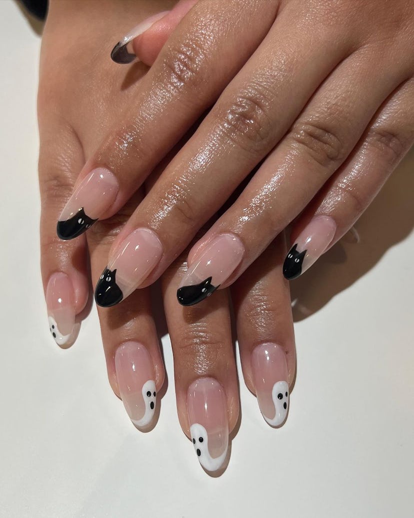 Try white ghosts and black cats as French tips for a 2023 Halloween nail design.