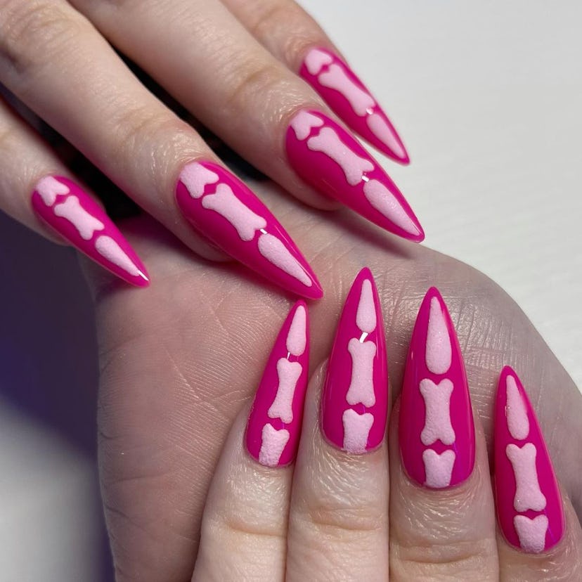 For simple Halloween nails, a Barbie pink bone nail art design is on-trend for 2023 and good for med...