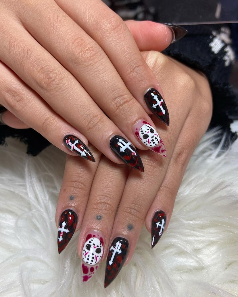 Try 'Friday the 13th' nail art with crosses for Halloween 2023.
