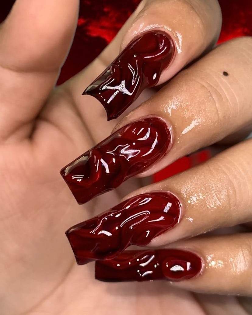 For trendy Halloween nails, a 3D red design is perfect.