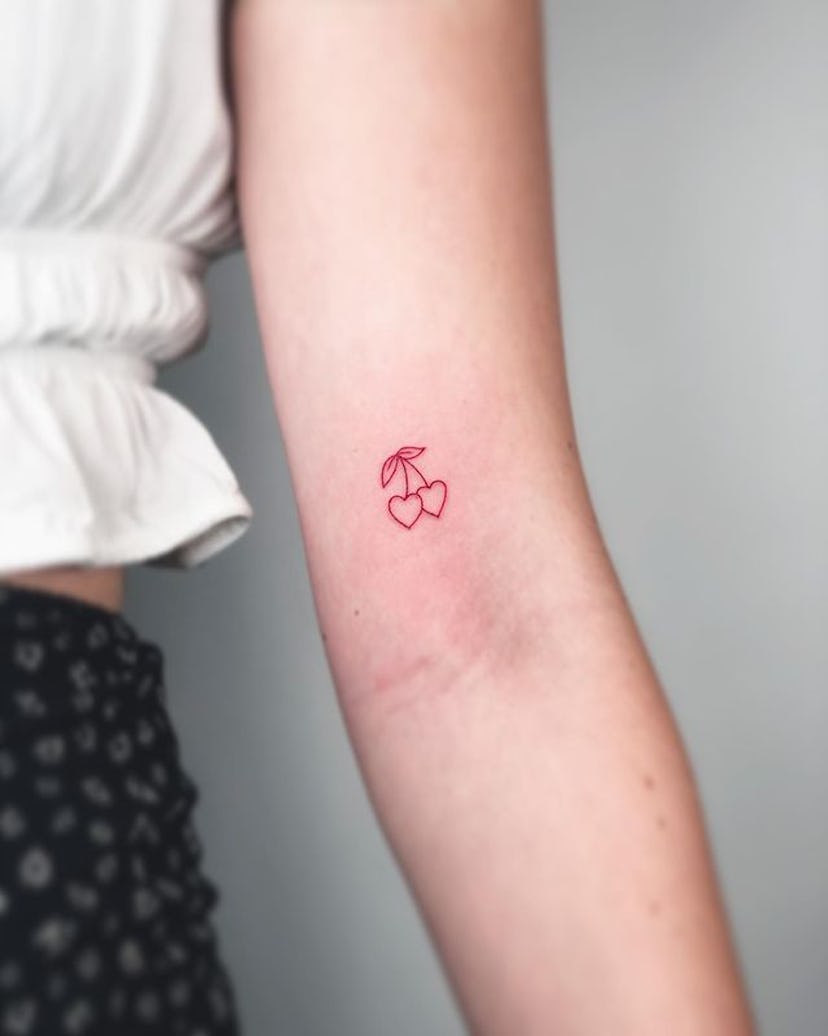 Small red ink tattoo.