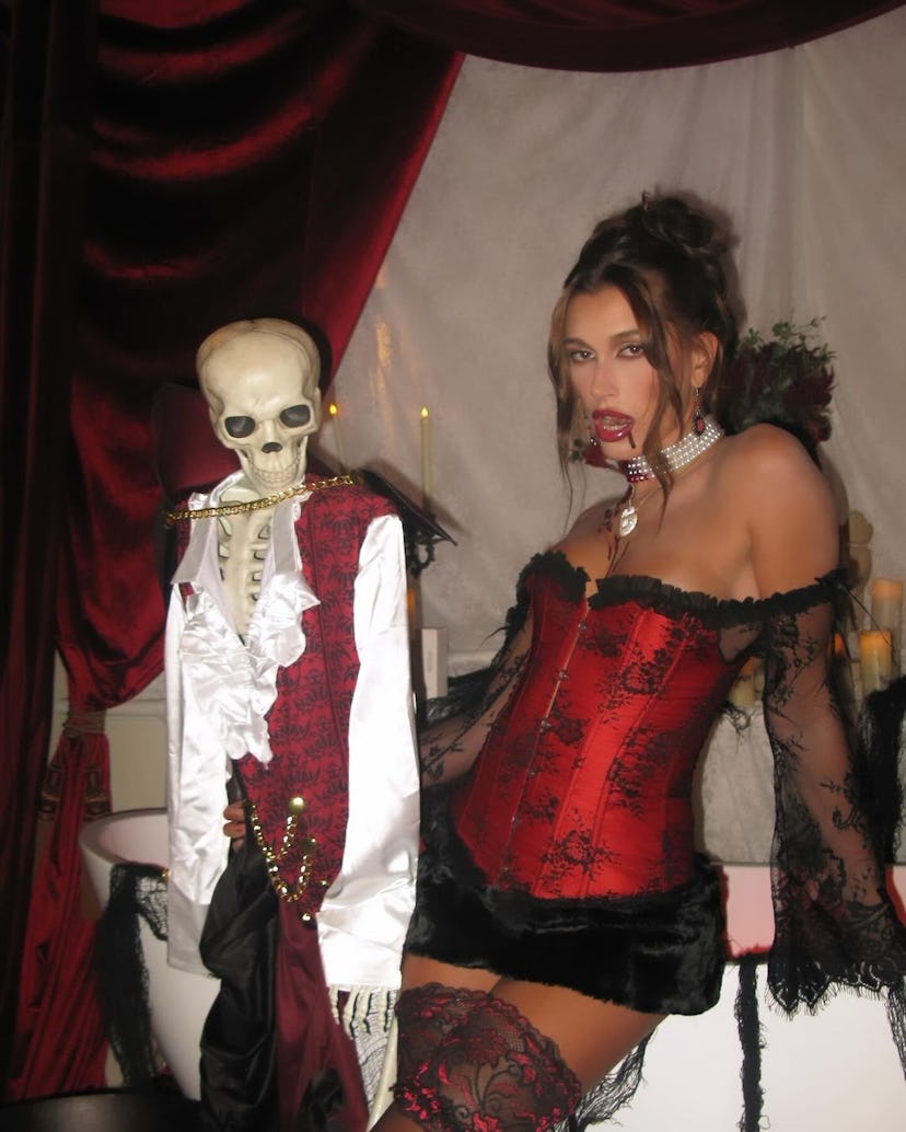 Hailey Bieber wears a corset as a vampire costume. 