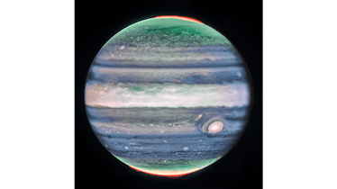 Eerie and soft cloudy bands cross the face of Jupiter. A broad hazy belt sits near the center, and i...