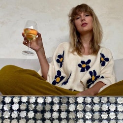 Taylor Swift daisy sweater and wine glass