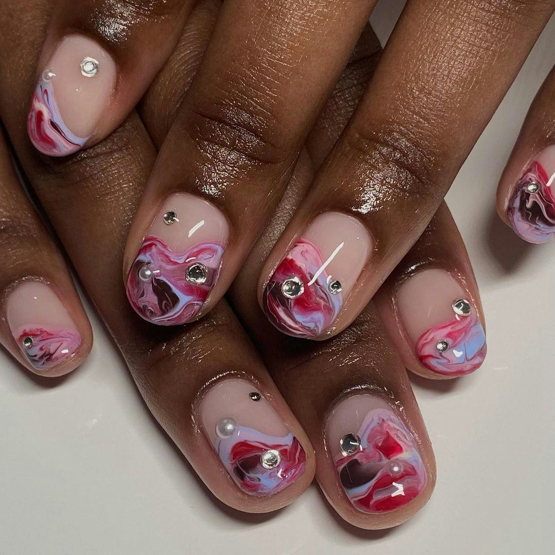 A pink &amp; purple swirl nail art design for scorpio season 2023 manicure ideas.