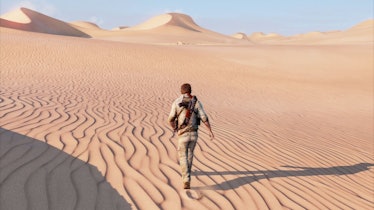Nathan Drake walks through the desert in Uncharted 3: Drake's Deception