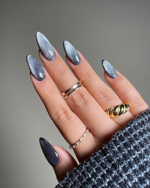 Black chrome nails are a popular manicure trend for winter 2024.