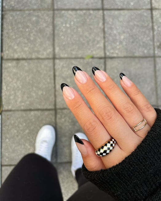 A trendy black French tip nail art design for scorpio season 2023 manicure ideas.