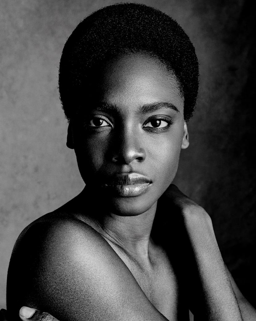 a black and white portrait of a woman with a short afro hairstyle