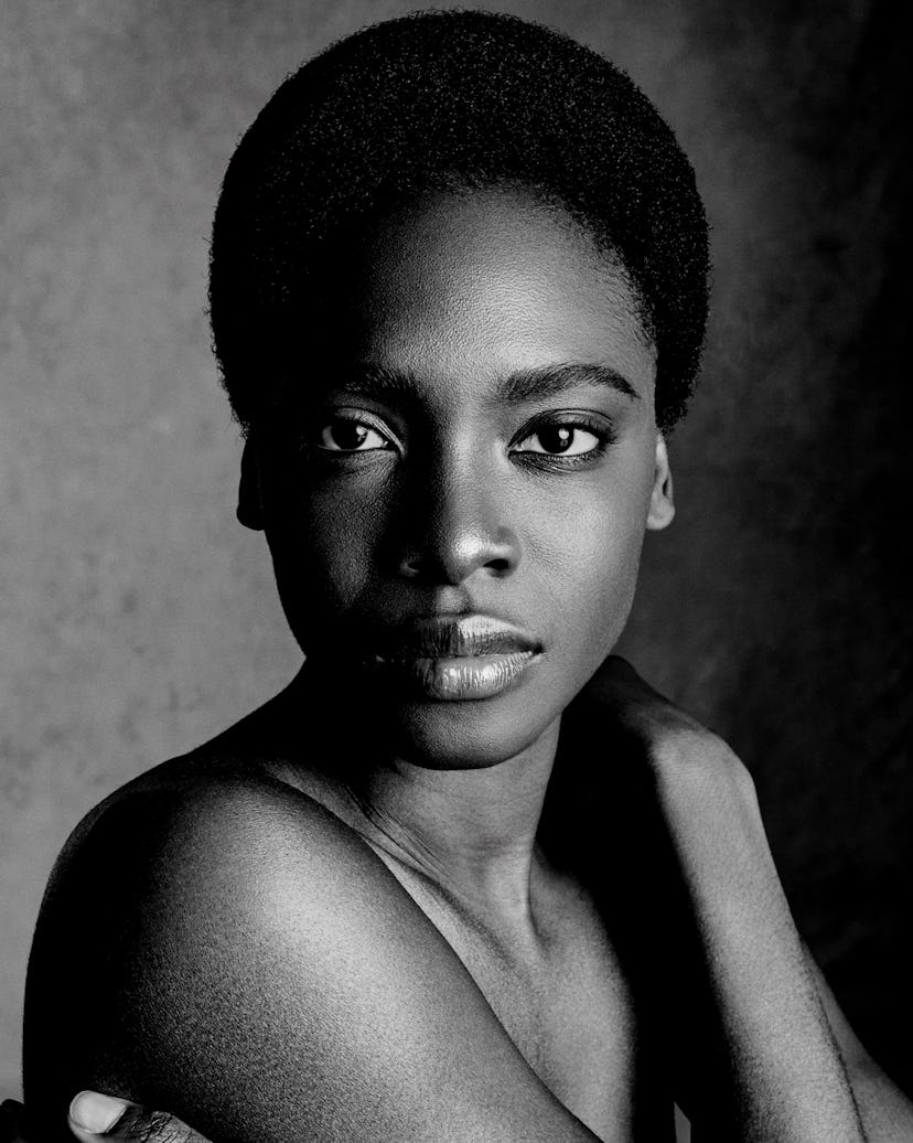 a black and white portrait of a woman with a short afro hairstyle 