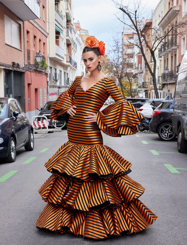 Penelope Cruz in orange and black striped dress