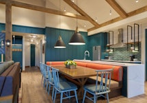 A living room and kitchenette designed by Nate Berkus for the Woodland Villas at Great Wolf Lodge Po...