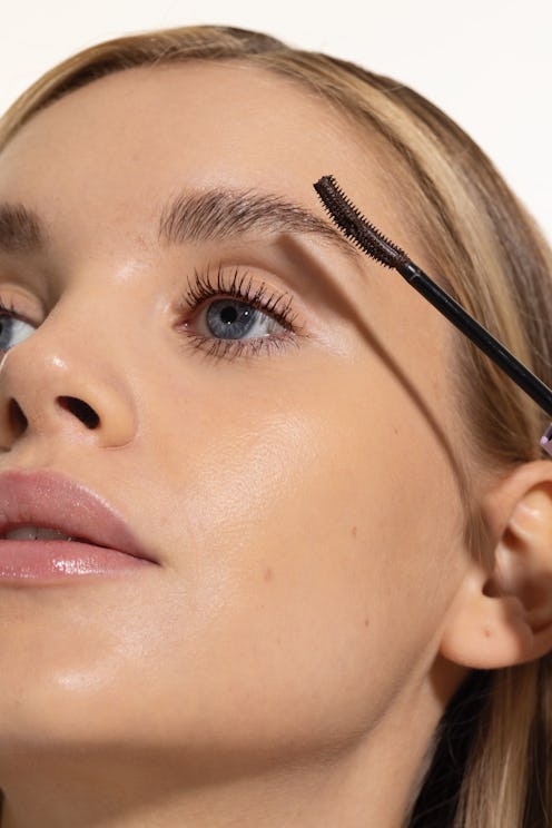 Model applying Tower 28 make waves mascara