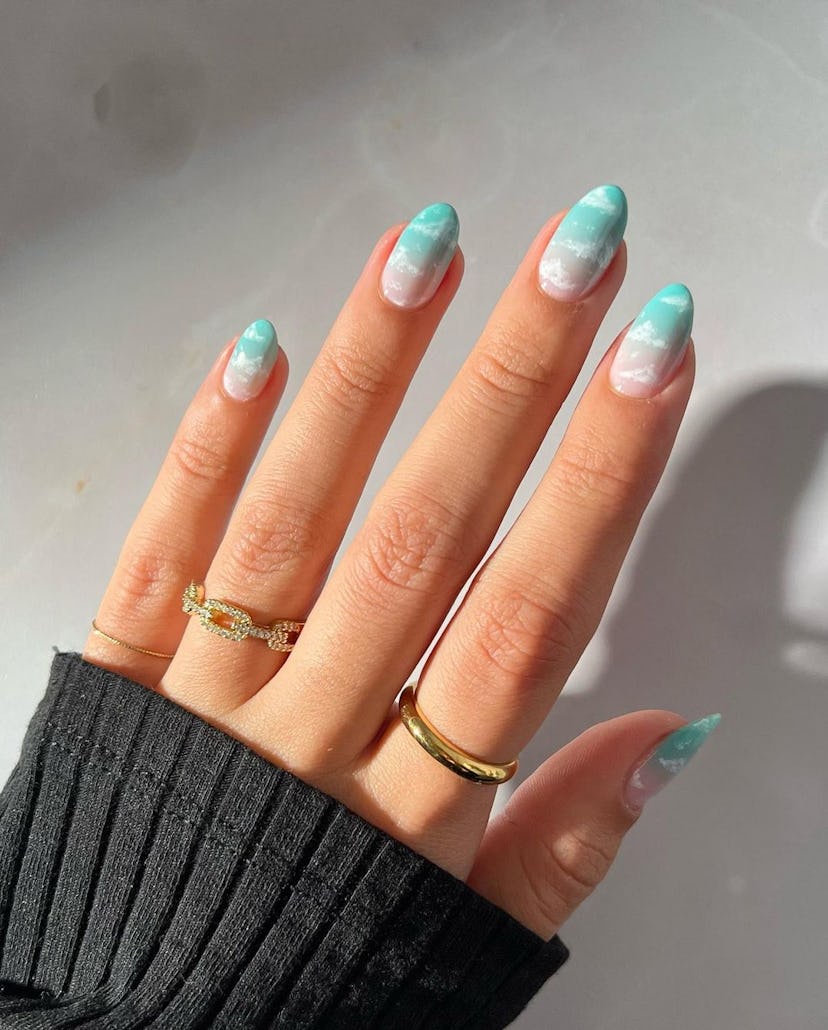 Cloud-filled sky blue nails that are inspired by 1989 (Taylor’s Version).