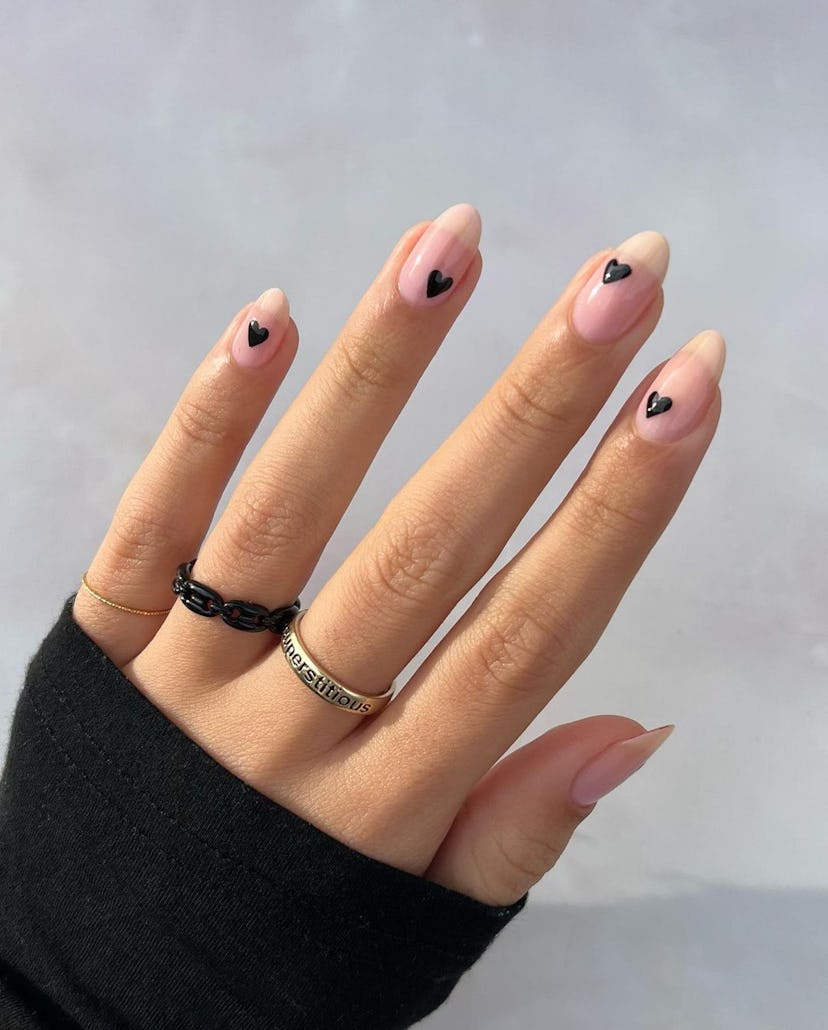 A minimal manicure design with tiny black heart nail art inspired by “Blank Space” on 1989 (Taylor’s…