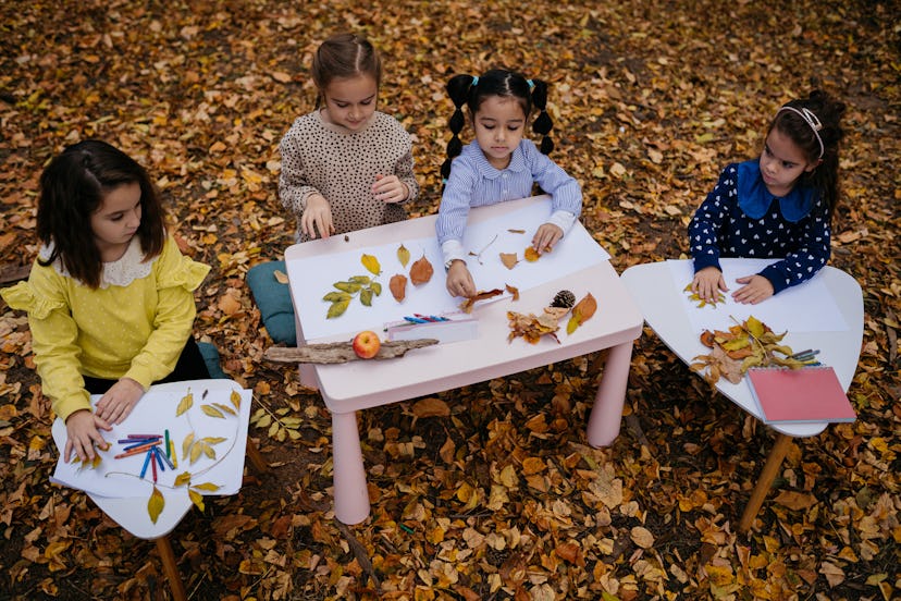 Kids play with fall leaves.