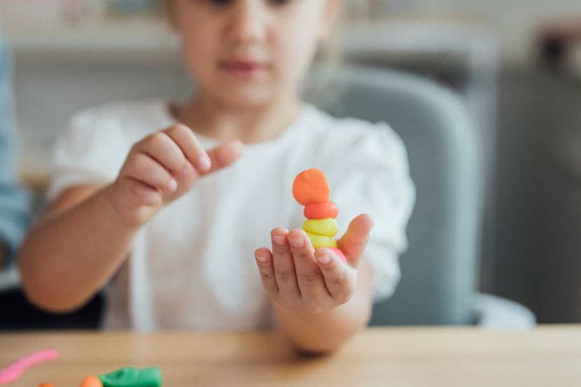 A child plays with playdough.