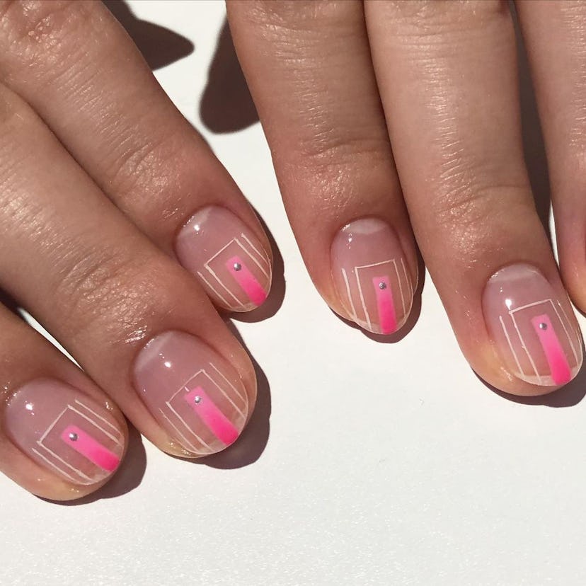 A negative-space nail art design with fine white lines and pops of hot pink nail polish on a clear n...