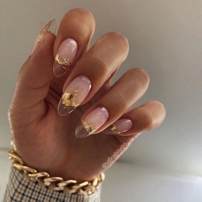 Simple clear almond-shaped nails with a classy gold foil design.