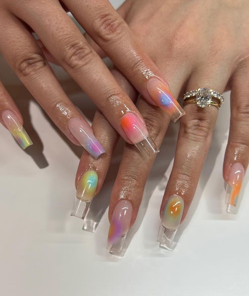 Here are trendy ideas for clear nails, like these aura nails in pretty shades of orange and purple.