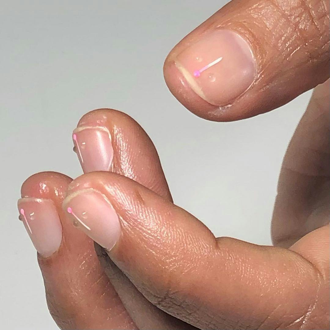 A simple nail art design for very short nails, try a clear coat of nail polish with small 3D dots.