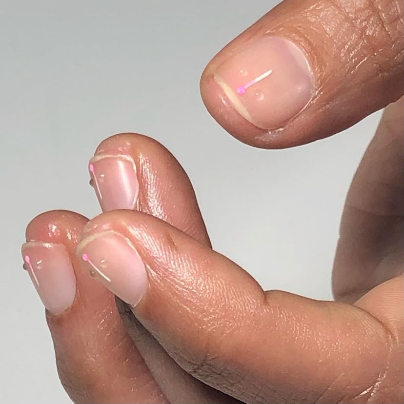 A simple nail art design for very short nails, try a clear coat of nail polish with small 3D dots.