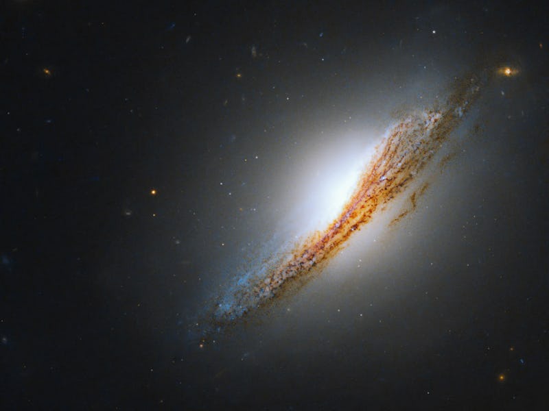 Lenticular, radio galaxy NGC 612 is seen edge-on in this new image from the Hubble Space Telescope. 