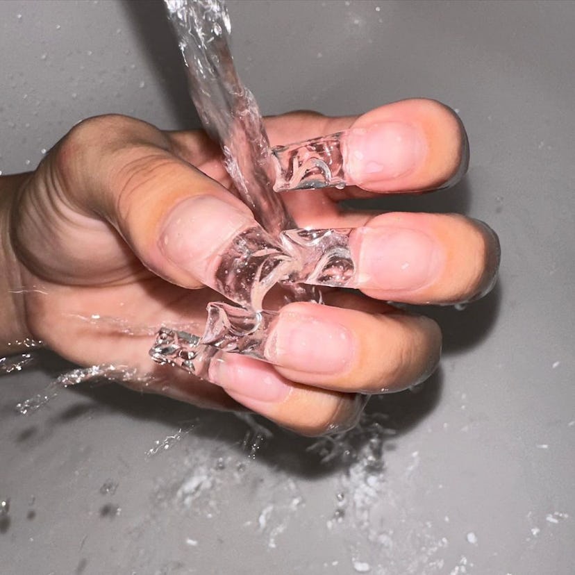Long clear square-shaped nails.