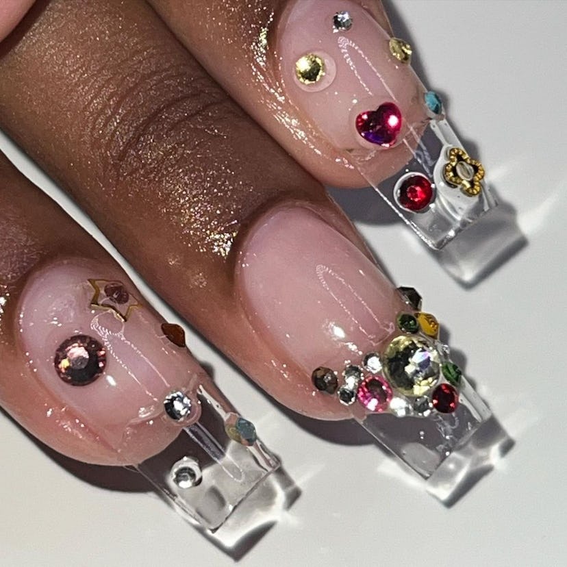 Long clear nails with gems.