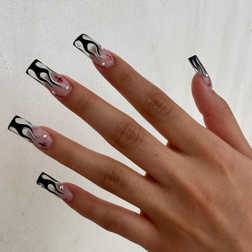 Square-shaped clear nails with a black & white flame nail art design.