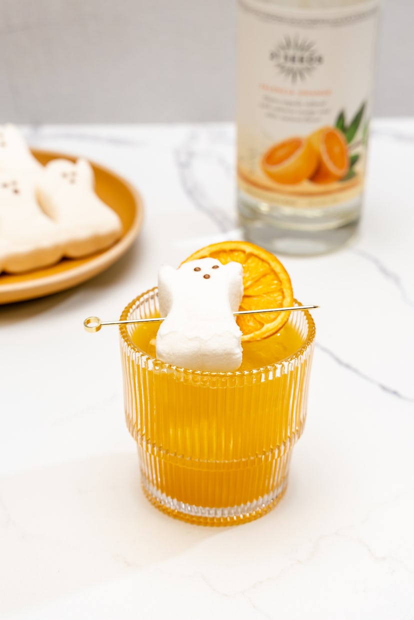 A pumpkin pie easy Halloween cocktail with marshmallow ghost garnish